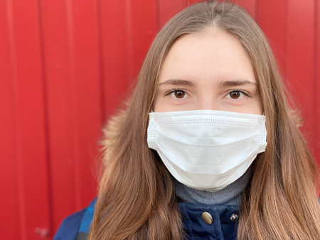 Attractive teenage girl wearing medical mask outdoor copy spaceの写真素材