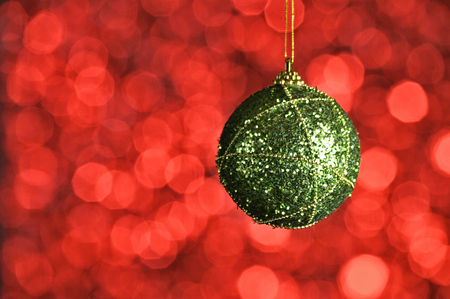Elegant colored New Year and Christmas ball on the background with light effect and bokeh.Orange,green.の写真素材