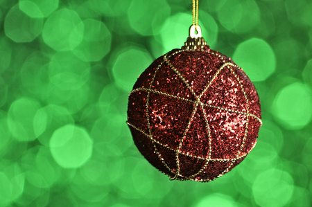 Elegant colored New Year and Christmas ball on the background with light effect and bokeh.Red,green,magenta,lilac,purpleの写真素材