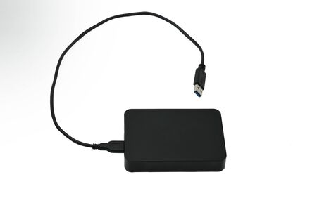 Portable hard drive for backing up various files on an isolated white background