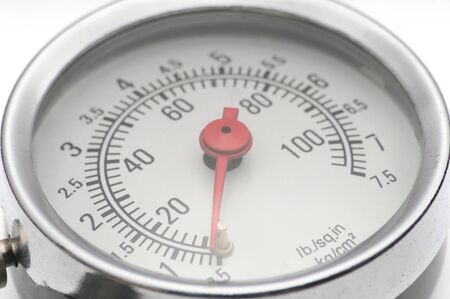Pressure gauge for measuring air pressure in automobile tires close-up on an isolated white backgroundの写真素材
