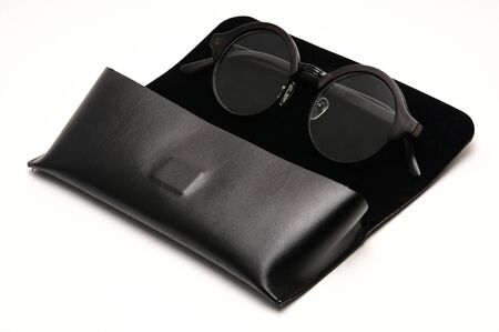 Transparent optical glasses with a eyeglass case on an isolated white background.