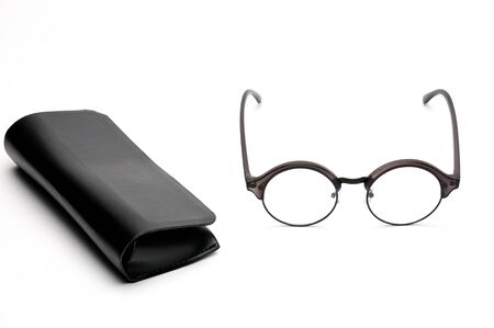 Transparent optical glasses with a eyeglass case on an isolated white background.