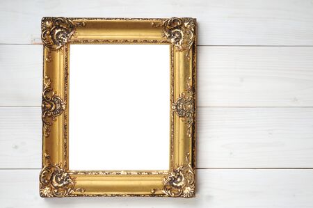 Vintage frame for paintings and photos in empire style on a wooden white backgroundの写真素材