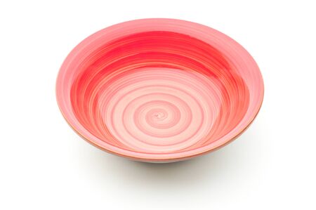 Ceramic plate in red on an isolated white backgroundの写真素材