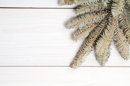 Christmas white wooden patterned background with Christmas tree branches and toys