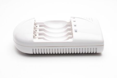 Adapter for charging batteries on an isolated white backgroundの写真素材