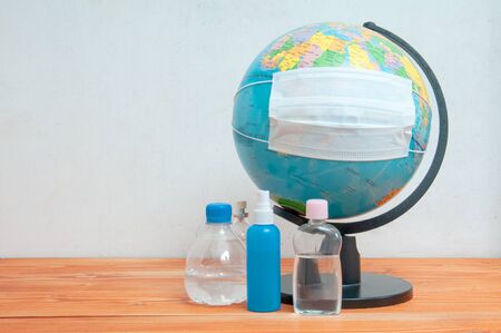 Protective medical face mask and effective alcohol solution for the prevention of open surfaces on the world globeの写真素材