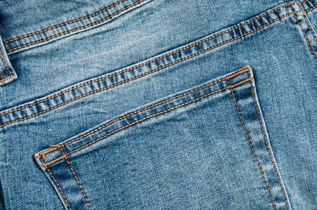Blue denim pants on a wooden background