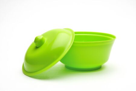 Green bowl for fruits and vegetables on an isolated white backgroundの写真素材