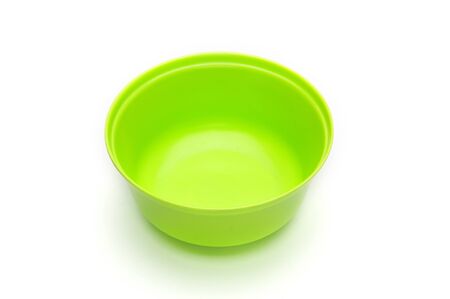 Green bowl for fruits and vegetables on an isolated white backgroundの写真素材