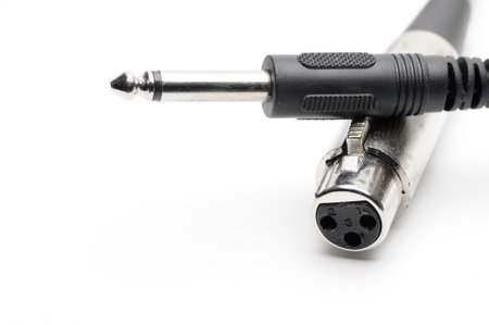 Audio cable with XLR and TRS jack connectors for microphones and professional audio equipment on an isolated white backgroundの写真素材
