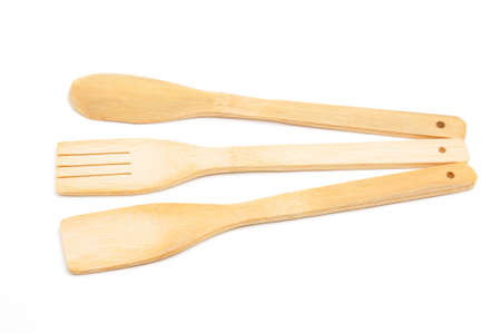 Wooden spoon, fork and spatula kitchen utensils for cooking food on isolated white background