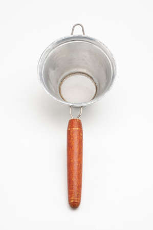 Vintage metal strainer for kitchen on isolated white backgroundの写真素材