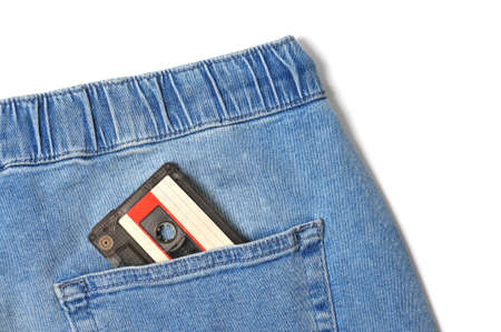 Vintage jeans with audio cassette in pocket close up on isolated white backgroundの写真素材