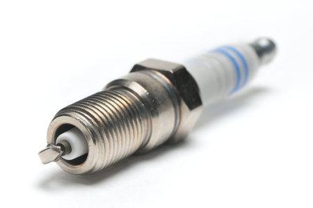 Spark plug for cars with a gasoline engine on an isolated white background