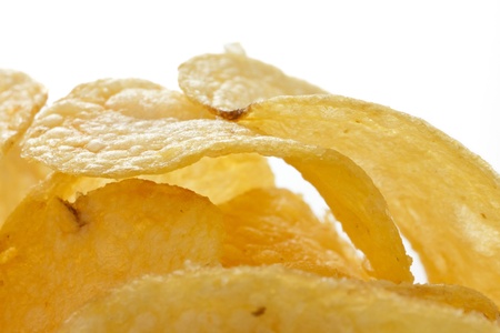Potato crisps or chips close up on white background
