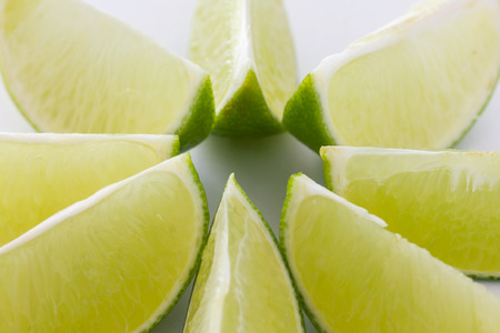 Lime wedges arranged in a regular pattern. Selective focus.の写真素材