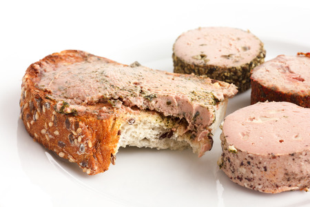 Rustic bread spread with pate  bite missing.の写真素材