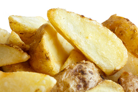 Detail of fried american potato wedges on white.の写真素材