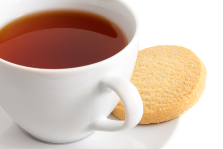 Detail of a white ceramic cup of rooibos tea with shortbread biscuits.の写真素材