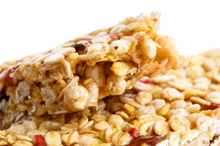 Deatail of one and half muesli bars on white.の写真素材