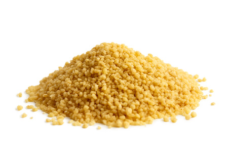 Heap of dry couscous isolated on white.の写真素材