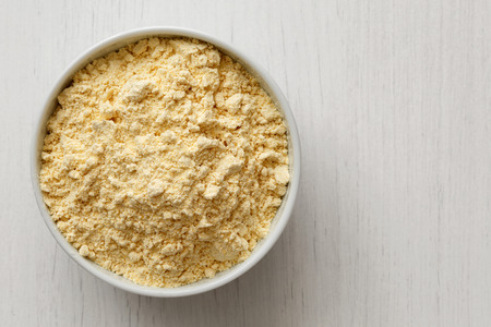 Chickpea flour
 in white ceramic bowl isolated on painted white wood from above.の写真素材