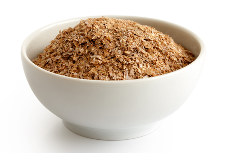 Wheat bran
 in white ceramic bowl isolated on white.の写真素材
