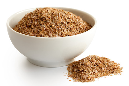 Wheat bran
 in white ceramic bowl isolated on white. Spilled bran.の写真素材