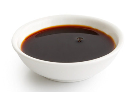 Soya sauce in white ceramic bowl isolated on white.の写真素材