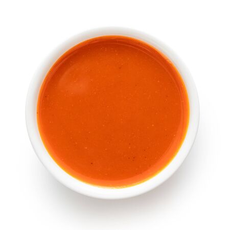 Peri peri chilli sauce in a white ceramic bowl isolated on white from above.の写真素材