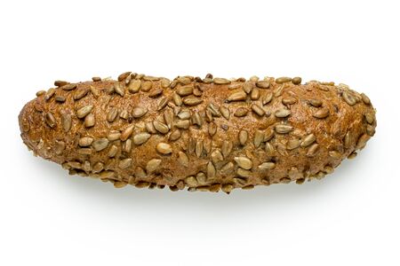 Long whole wheat bread roll with sunflower seeds isolated on white. Top view.の写真素材