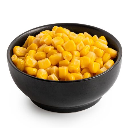 Canned sweet corn in a black ceramic bowl isolated on white.の写真素材