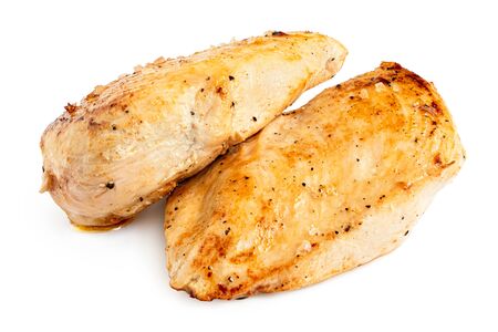Two whole pan roasted chicken breasts isolated on white.の写真素材