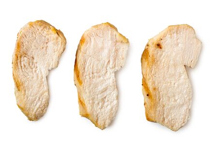 Three separated slices of grilled chicken breast isolated on white. Top view.の写真素材