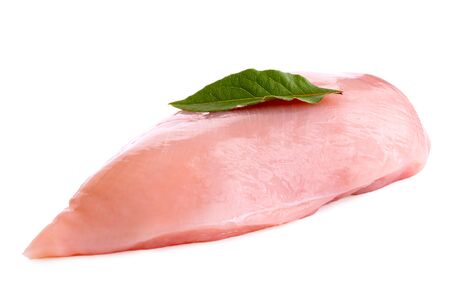 Whole uncooked boned chicken breast with bay leaf isolated on white.の写真素材