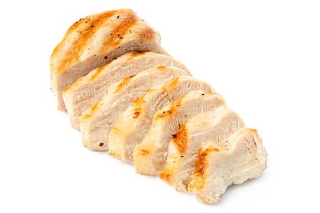 Partially sliced grilled chicken breast with grill marks, ground black pepper and salt isolated on white.の写真素材