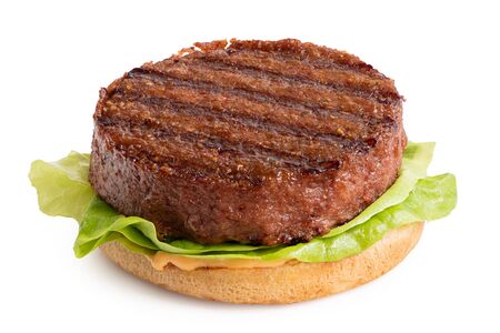 Freshly grilled plant based burger patty on bun with lettuce and sauce isolated on white.の写真素材