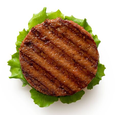 Freshly grilled plant based burger patty on bun with lettuce isolated on white. Top view.の写真素材