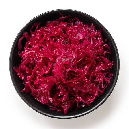 Red sauerkraut in a black ceramic bowl isolated on white. Top view.の写真素材