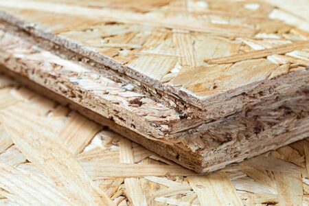 Detail of tongue and groove chip board lying on top of chip board. Blurred background.の写真素材