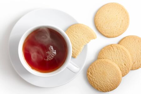 Cup of hot rooibos tea with two square shortbread biscuits isolated on white. White porcelain. Top view.の写真素材