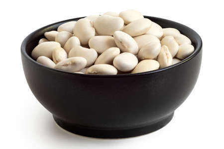White beans in a black ceramic bowl isolated on white.の写真素材