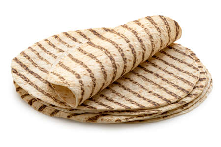 Folded tortilla on top of a stack of plain tortilla wraps with grill marks isolated on white.