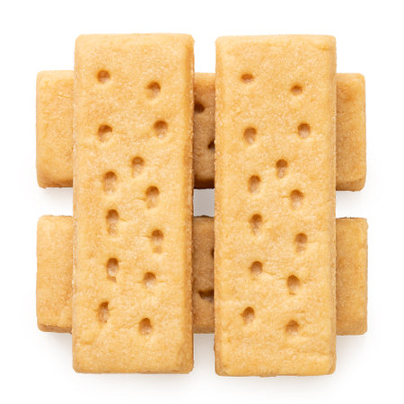 Stack of four butter shortbread finger biscuits isolated on white. Top view.の写真素材