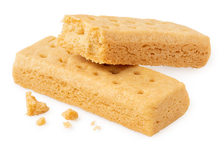 Two butter shortbread finger biscuits isolated on white. One partially eaten.の写真素材