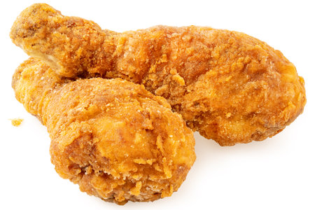 Two crispy fried chicken drumsticks isolated on white.の写真素材