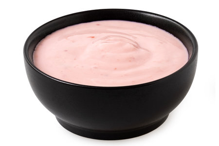 Strawberry yogurt in a black ceramic bowl isolated on white.の写真素材