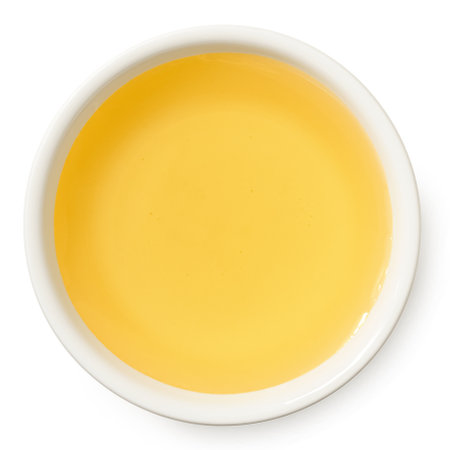 Agave syrup in a white ceramic bowl isolated on white. Top view.の写真素材